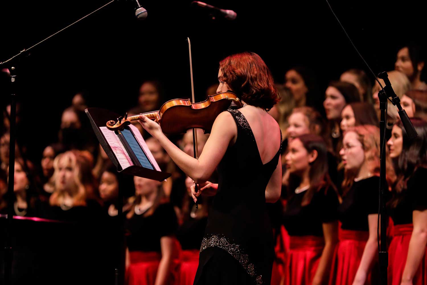 Choir performs with an accompanying violinist