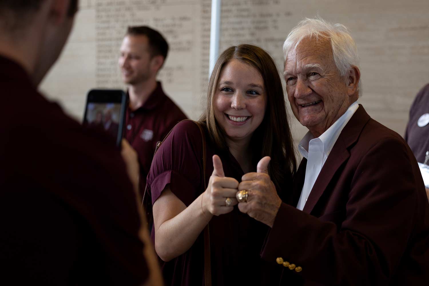 Student and her grandfather smile and post for a photo on ring day