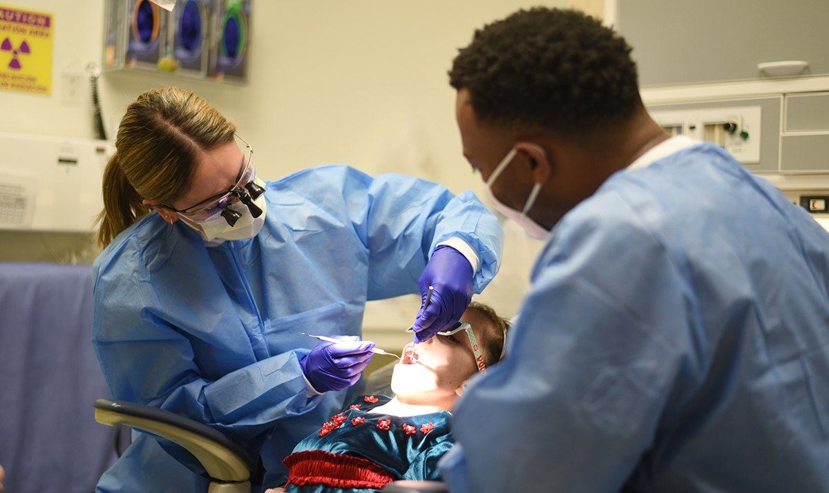 School of Dentistry students work with a patient to improve their skills and knowledge