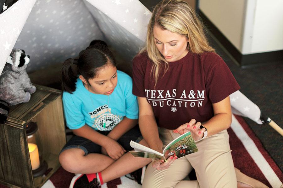 School of Education and Human Development student reads to a child