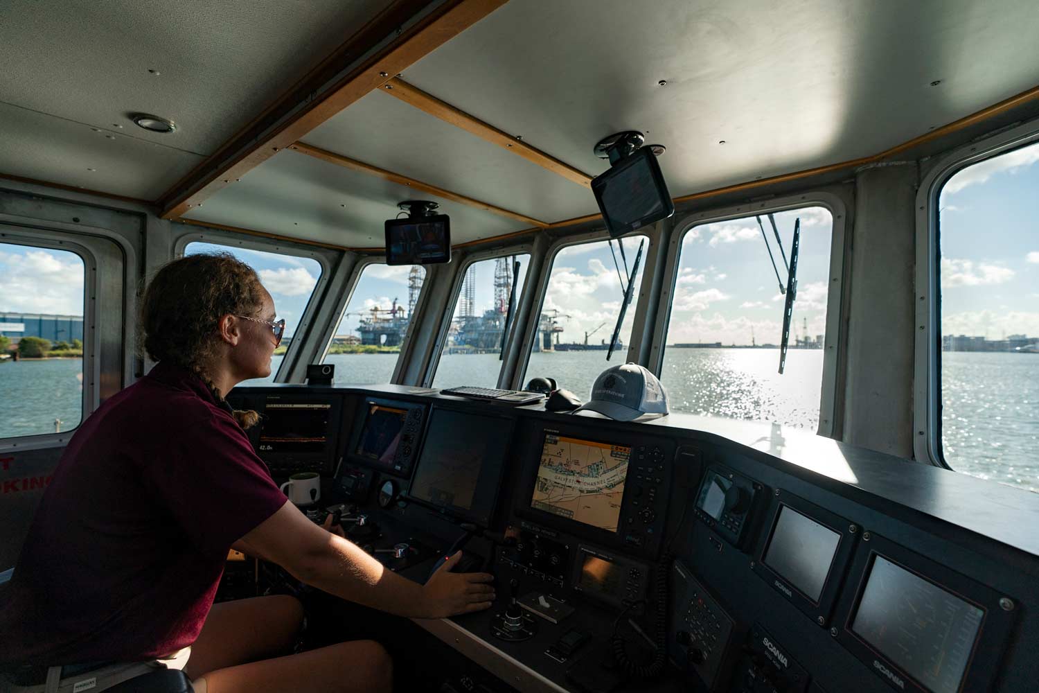 Texas A&M Galveston student drives a boat in the Gulf of Mexico