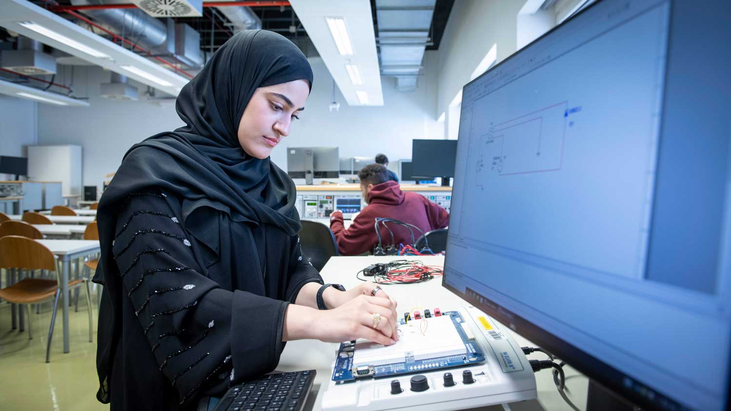A student builds a circuit on the Texas A&M Qatar campus