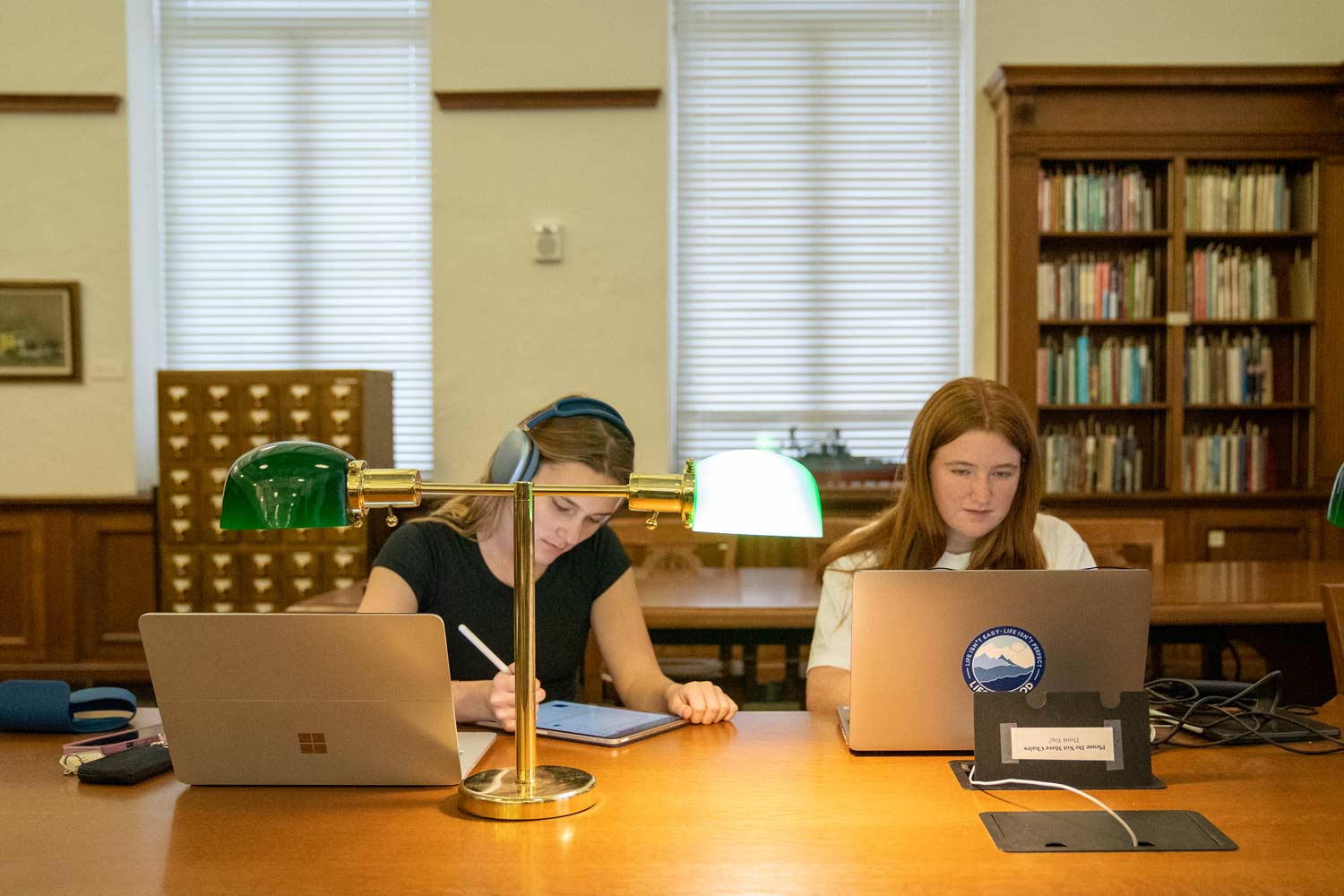 Two students study in Cushing Library on campus
