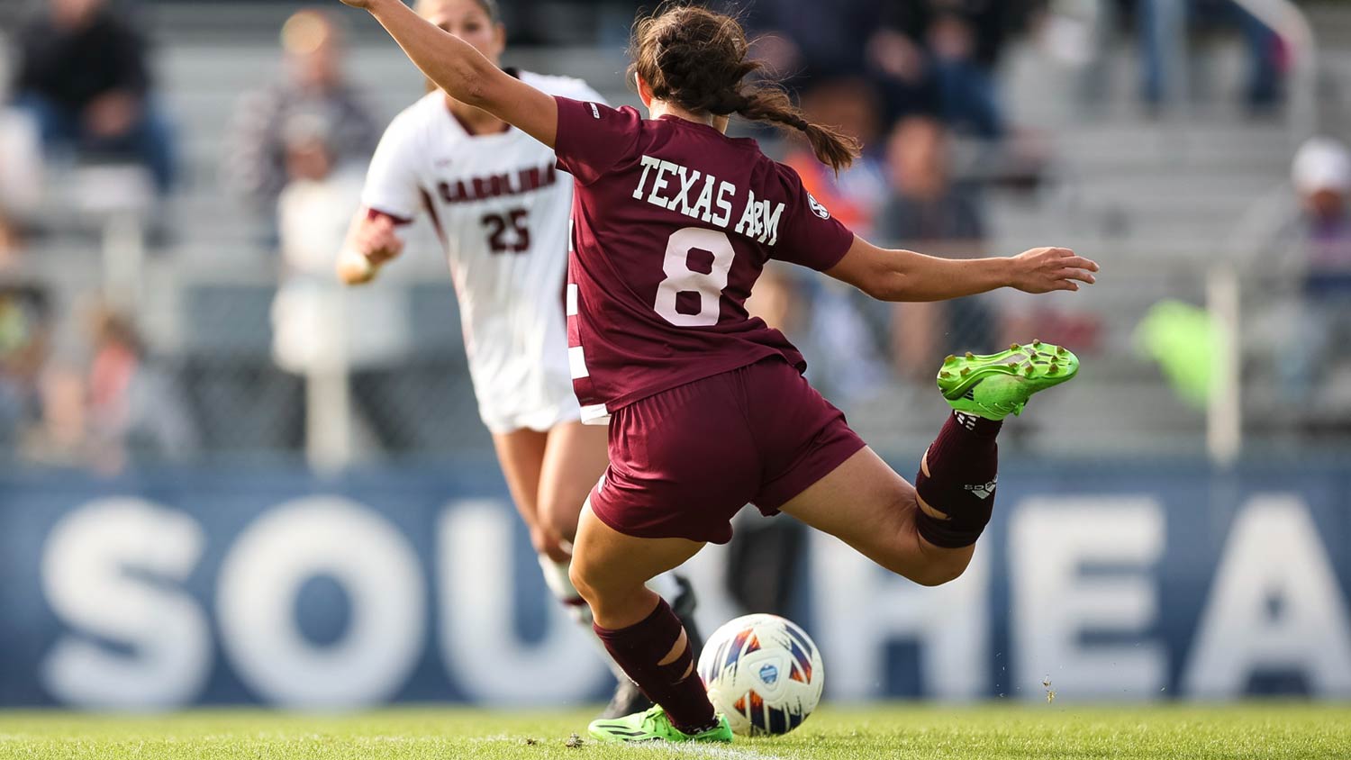 A Texas A&M soccer player prepares to kick the ball past the defense