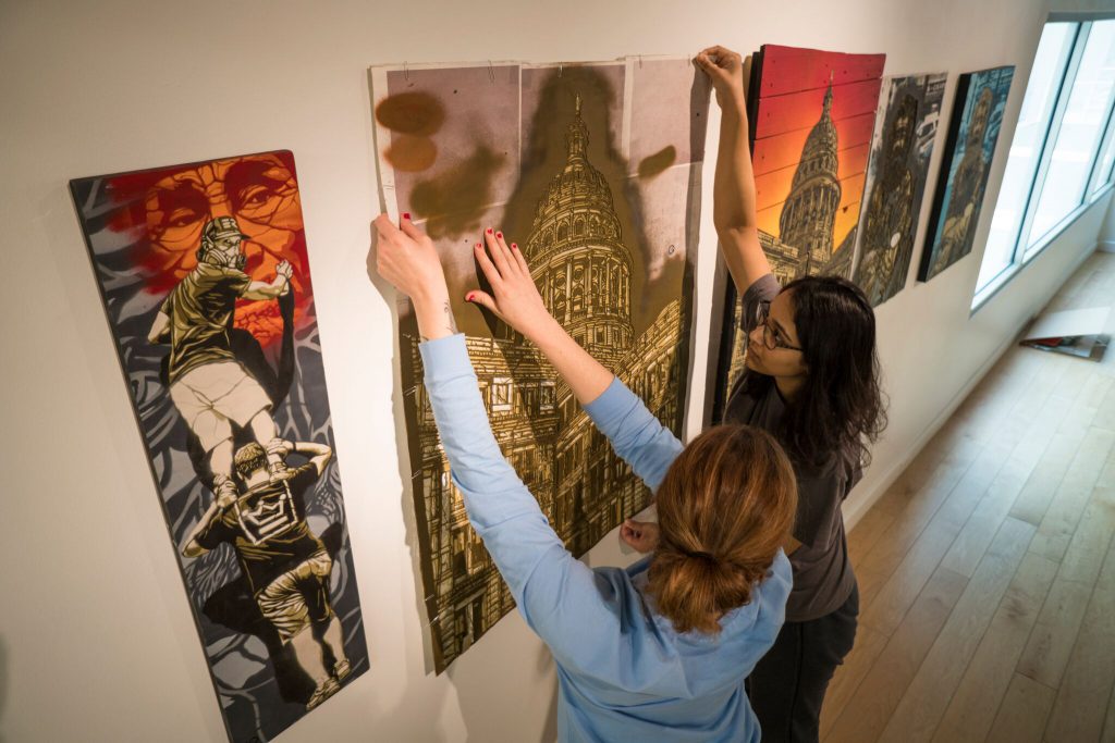 Texas A&M Students hang art in the James R. Reynolds Gallery