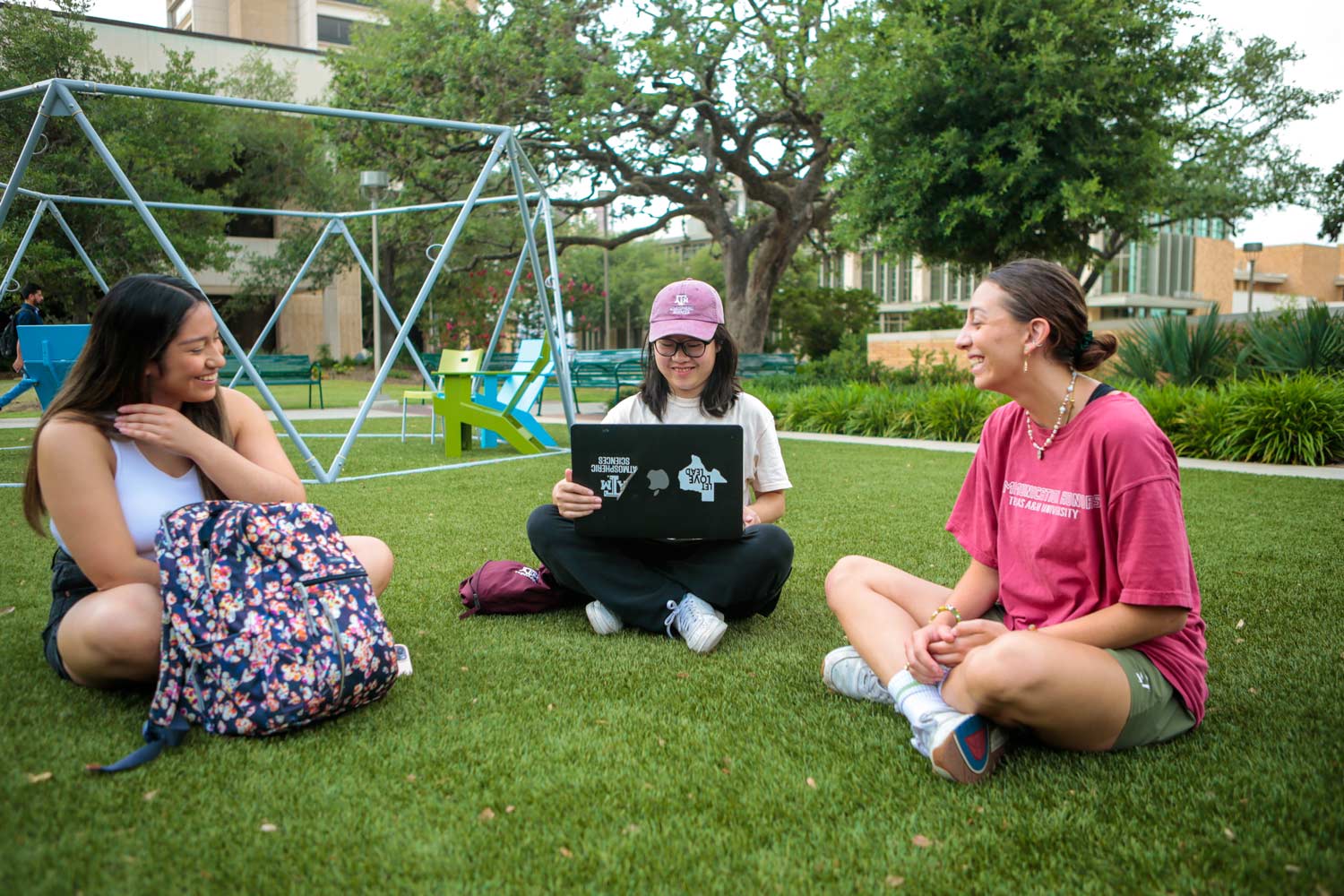 Students enjoying the greenspace outside the Student Services building