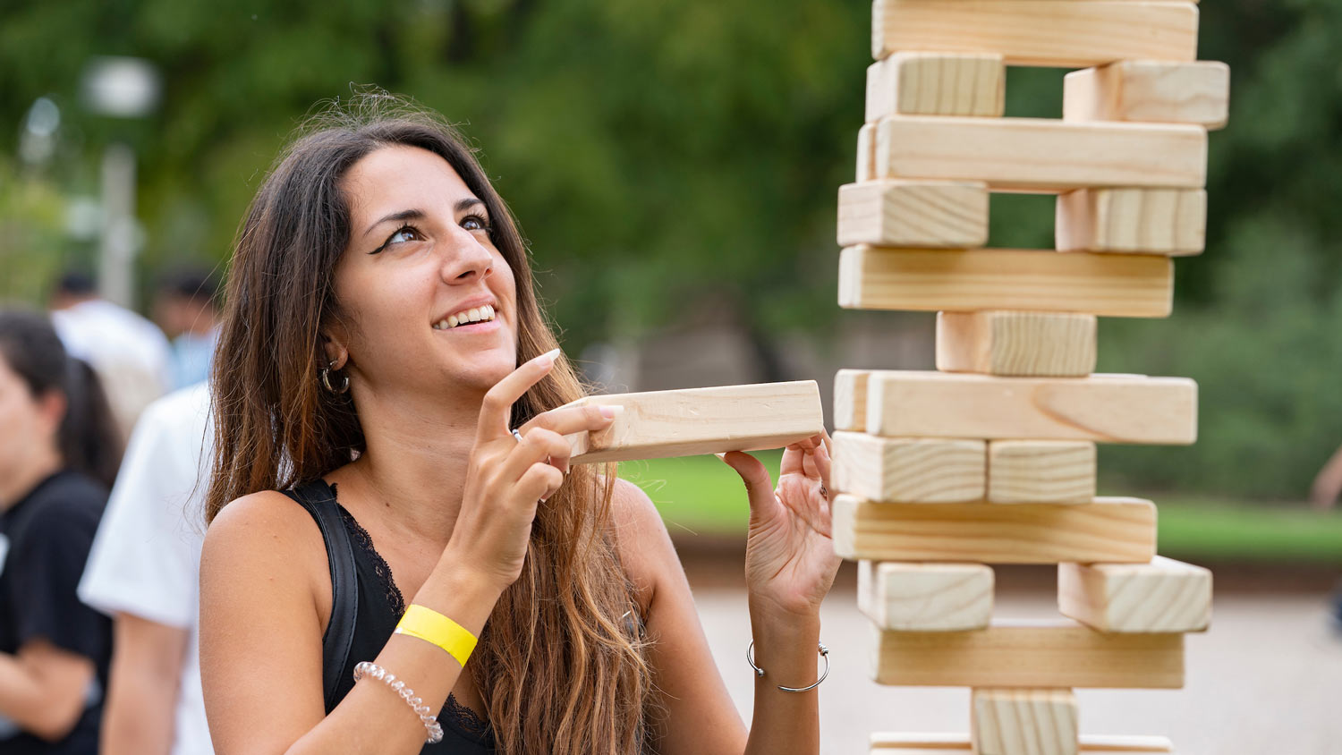 Student places a block on a tumbling tower