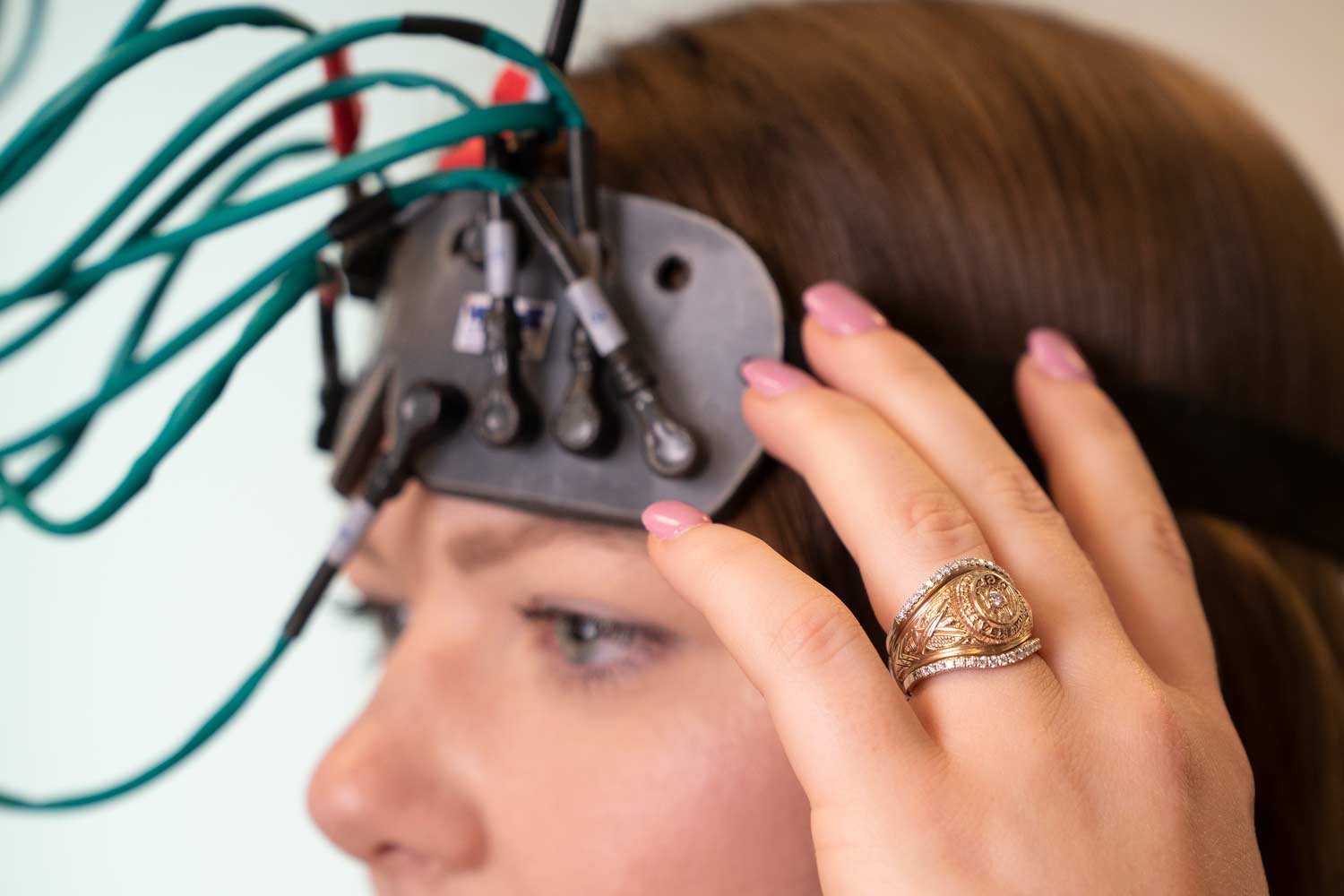 An Aggie student with wires connected to her head for a research project