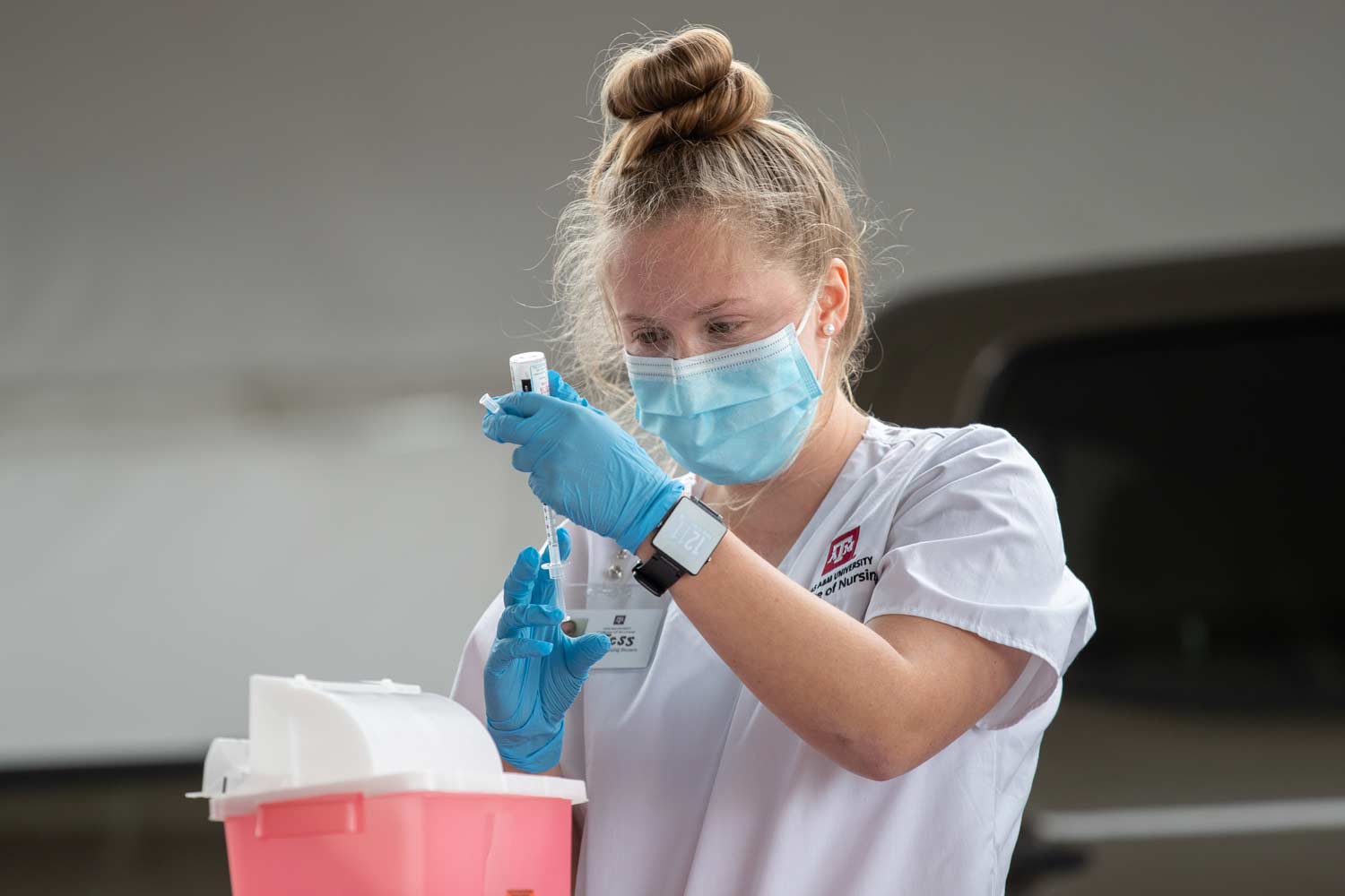 Texas A&M nursing student preparing a vaccine shot.