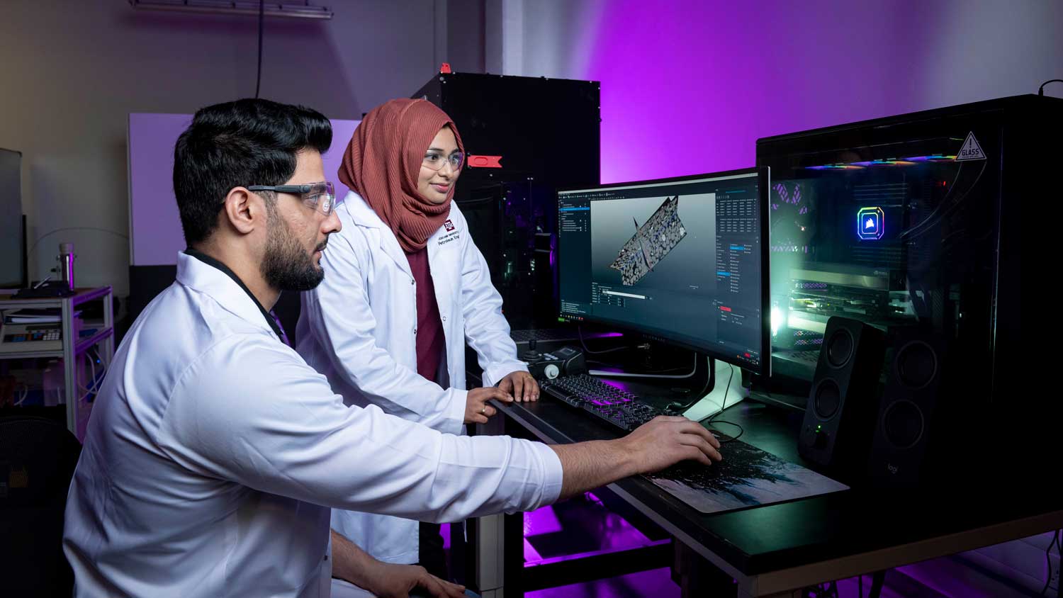 Two students look at visual models on a computer