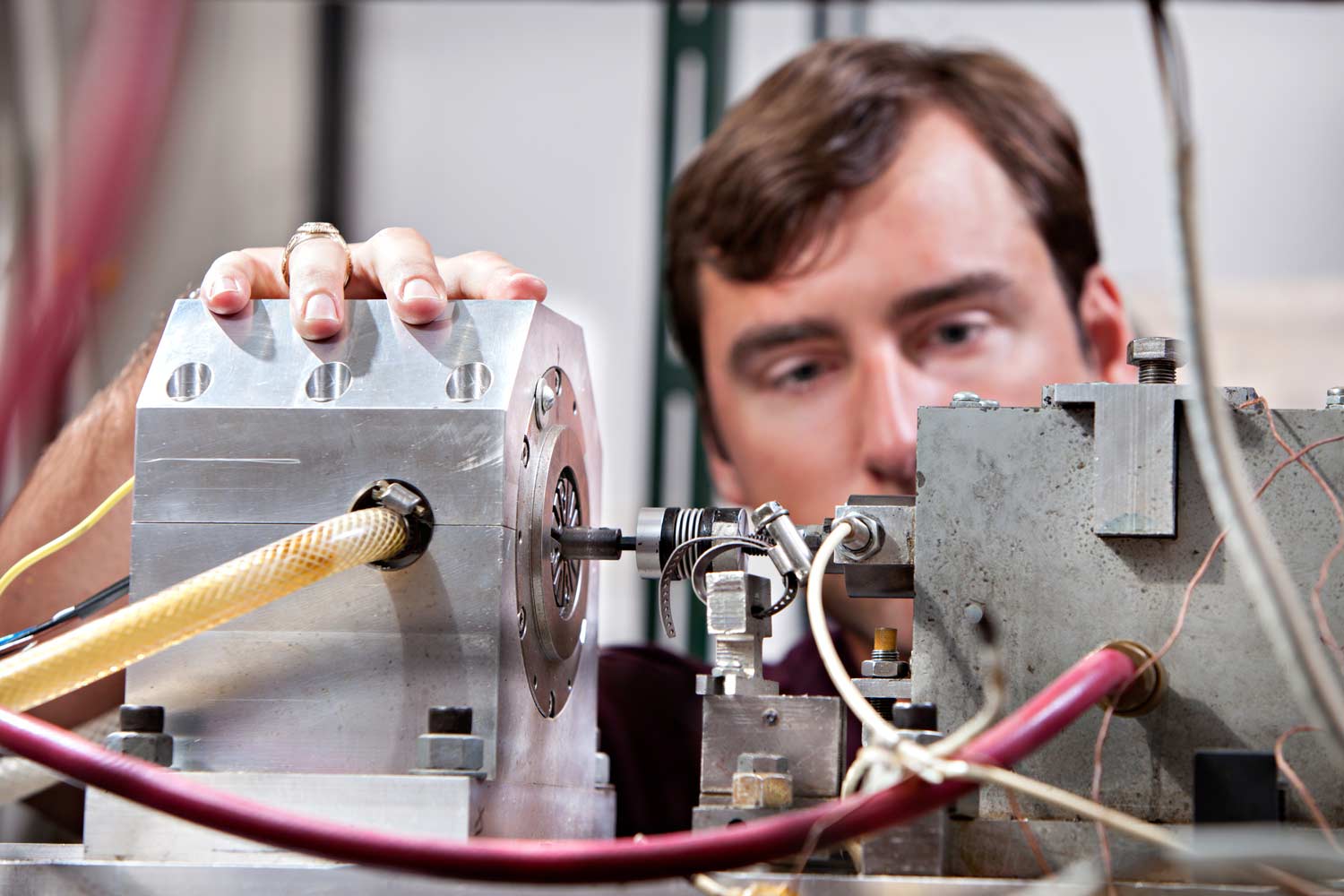 Texas A&M student conducting research on industrial equipment.