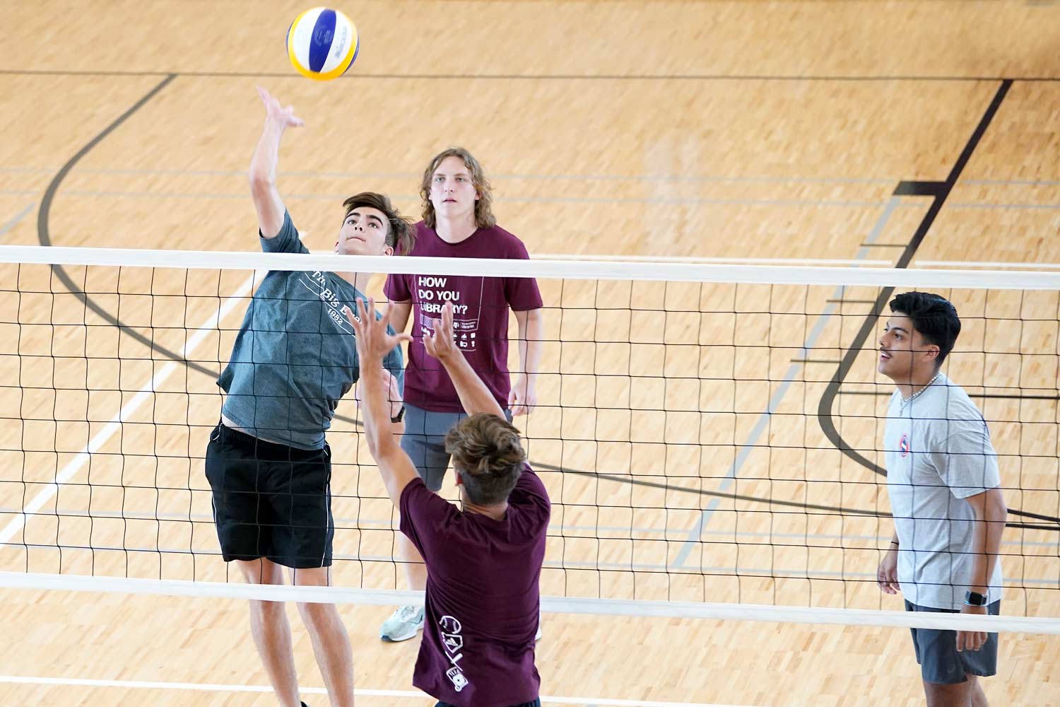 Aggies playing club volleyball at an indoor court in the West Campus rec center