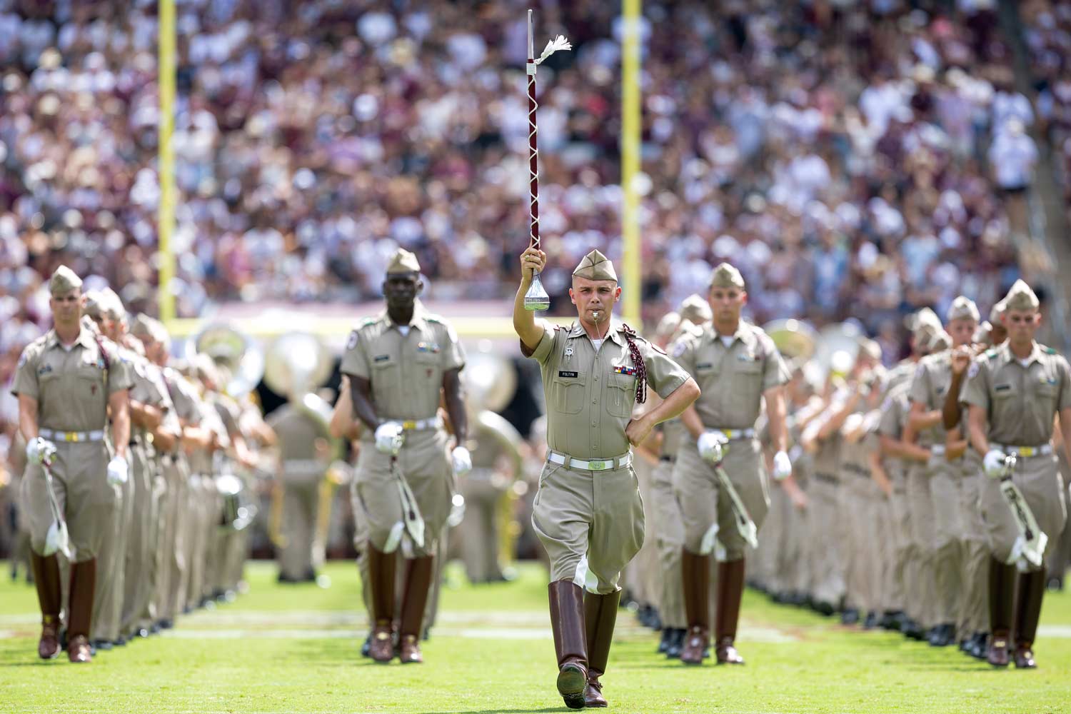 The Fightin' Texas Aggie Band drum major leading the band on Kyle Field