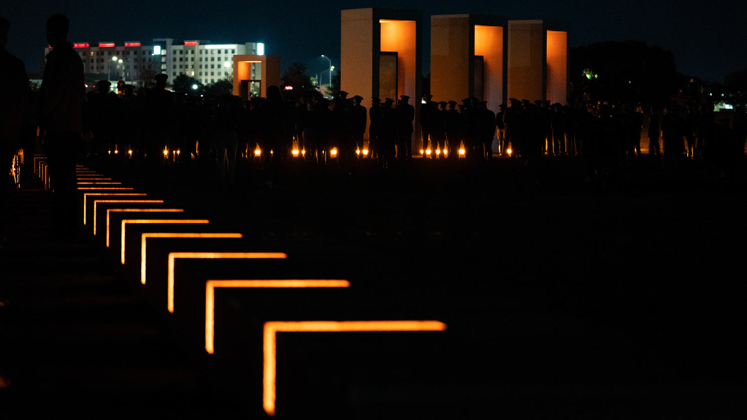 The history walk portion of the Bonfire Memorial lit up at night,
