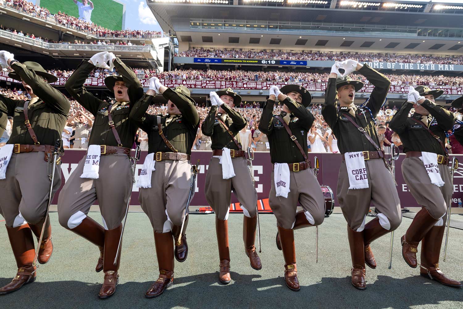 Several Corps of Cadets seniors whoop after a touchdown at a football game