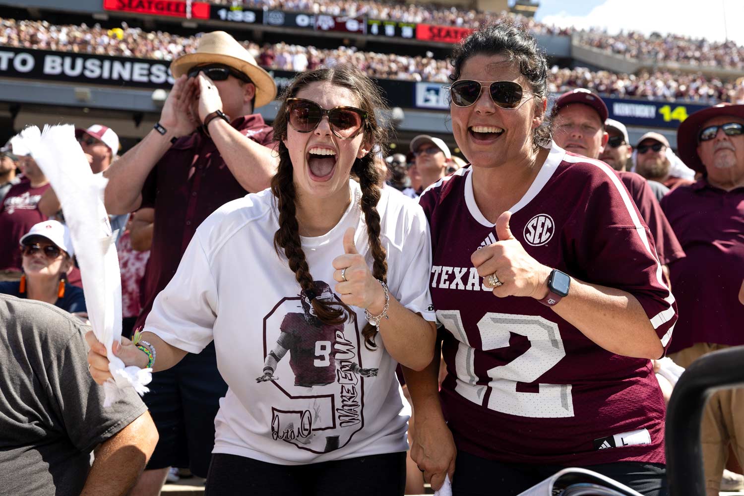 Two Texas A&M Students pose for the camera during a Fightin' Texas Aggie football game