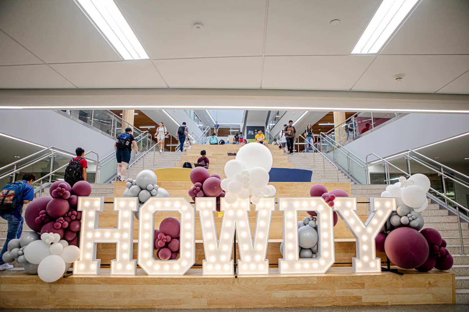 Light-up HOWDY sign on the indoor main staircase of Zachry Engineering Education Complex on the Texas A&M Campus