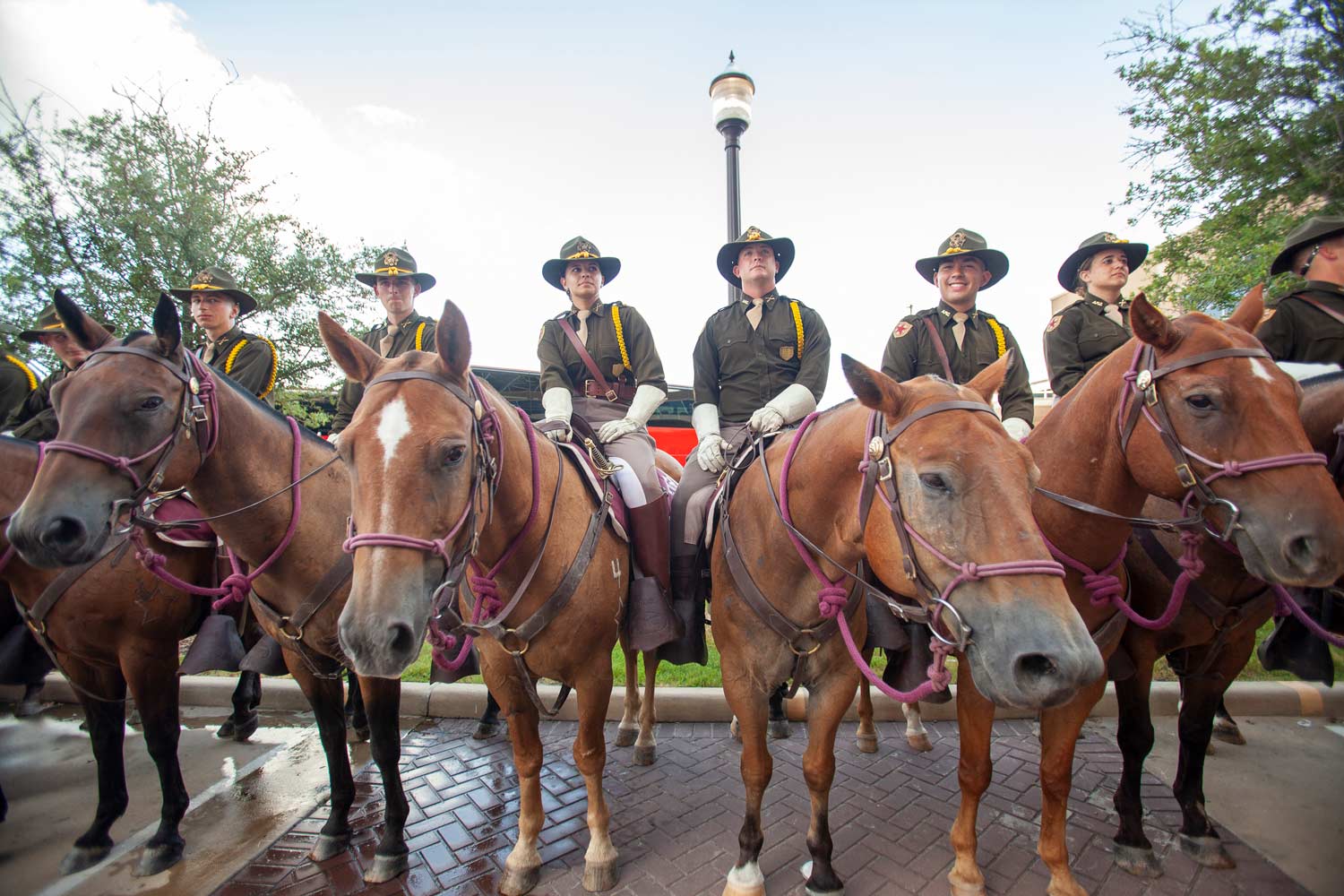 Members of Parsons Mounted Cavalry sit atop their horses as the Corps marches in on gameday