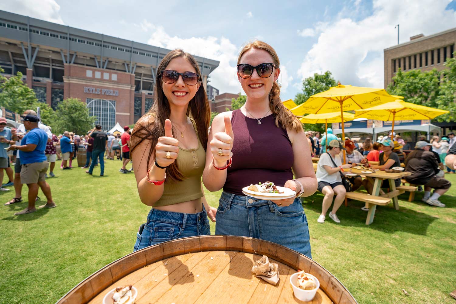 Aggies enjoy food from a tailgating event in Aggie Park