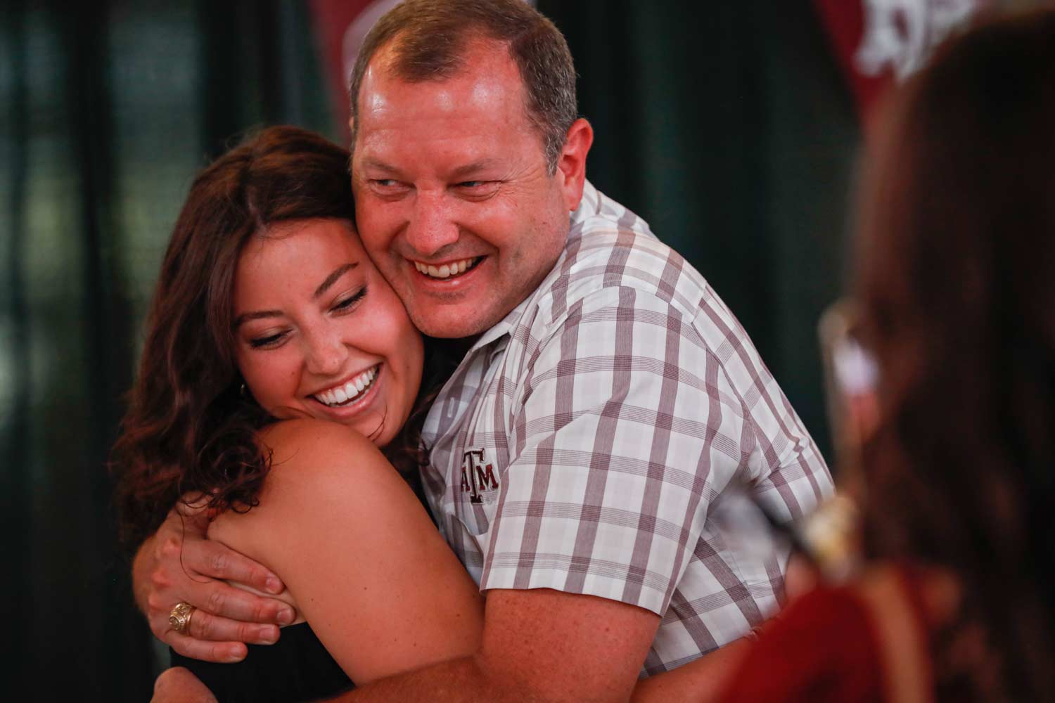 Texas A&M student and family member hugging on ring day